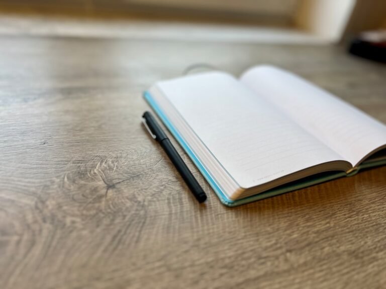 Notebook and pen for science fiction writing prompt articles