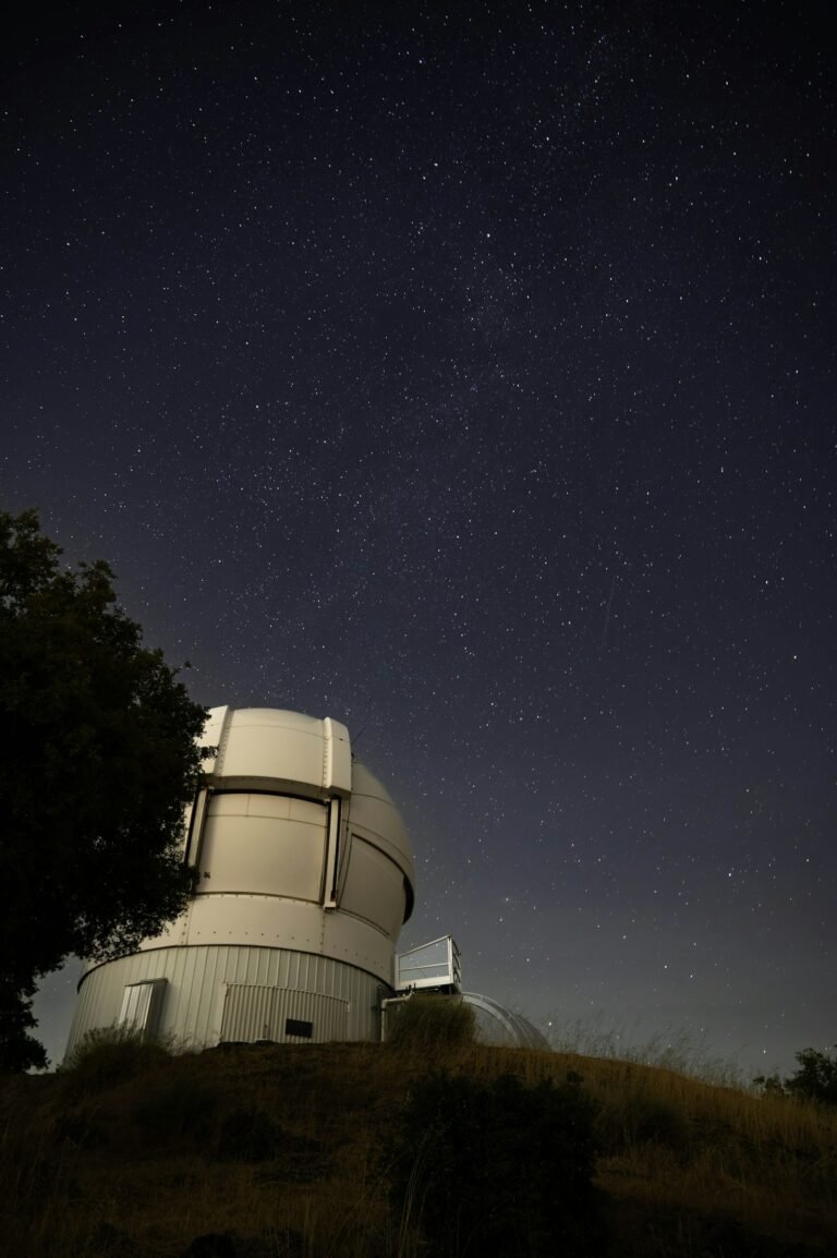 Telescope under a starry night sky